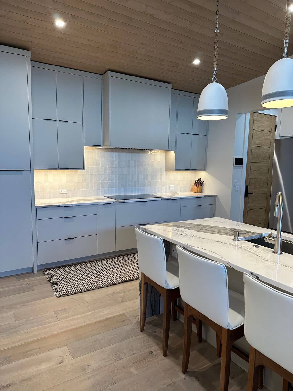 A kitchen with a table and chairs in it.