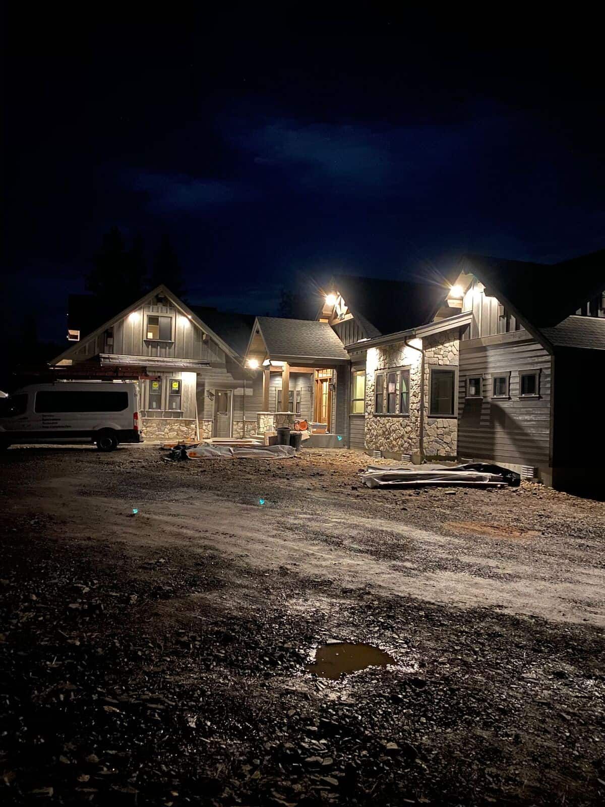 A group of houses are being built at night.