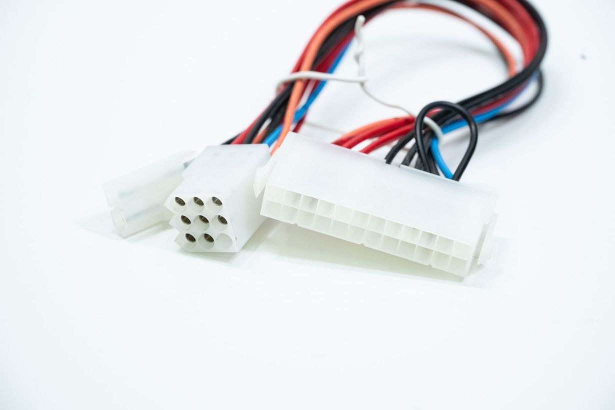 White electrical power connectors with red, black, and blue wires on a white background