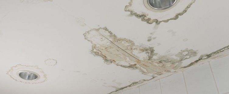 Water leaking from damaged ceiling
