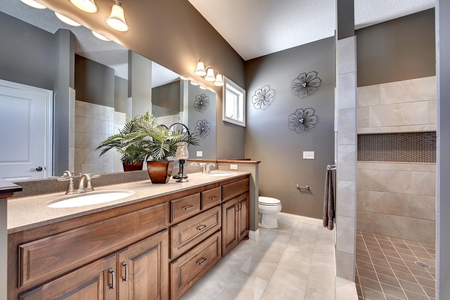 a bathroom with two sinks, a toilet and a walk in shower