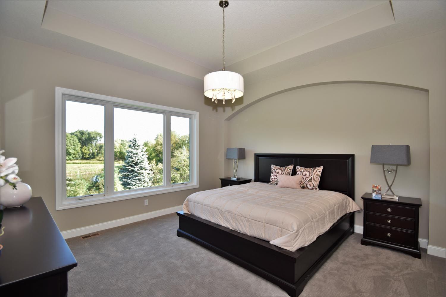 a bedroom with a large bed and a large window