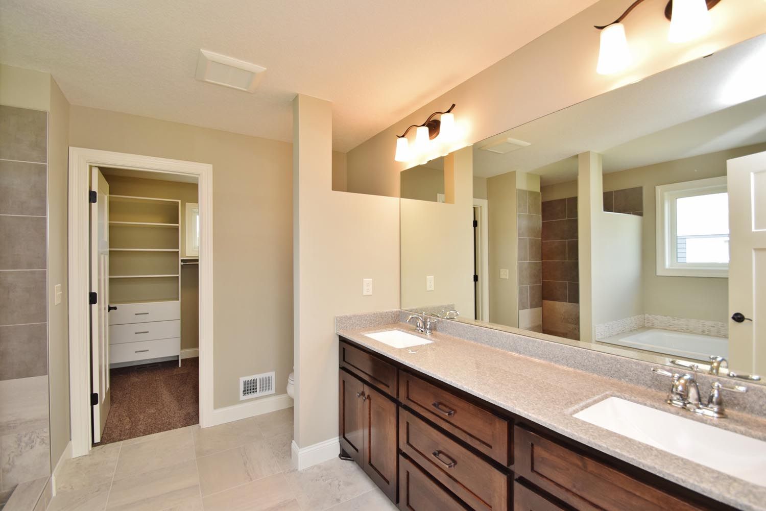 a bathroom with two sinks and a large mirror