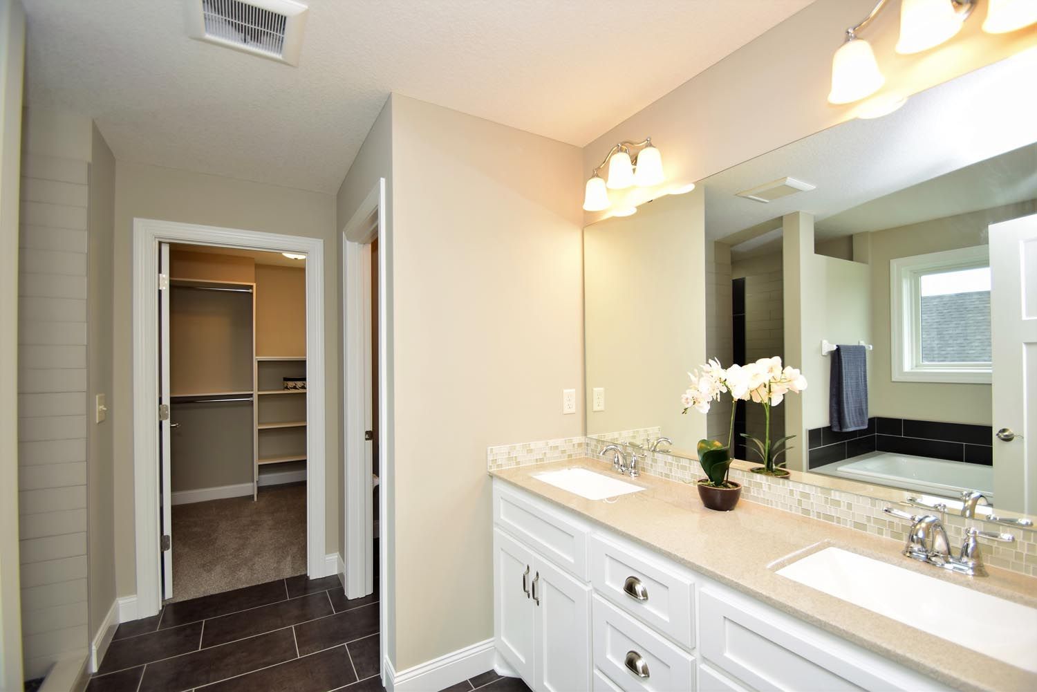 a bathroom with two sinks and a large mirror