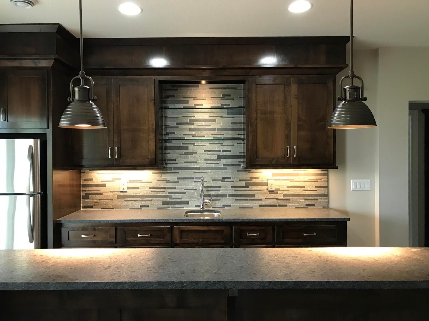 a kitchen with wooden cabinets and a granite counter top