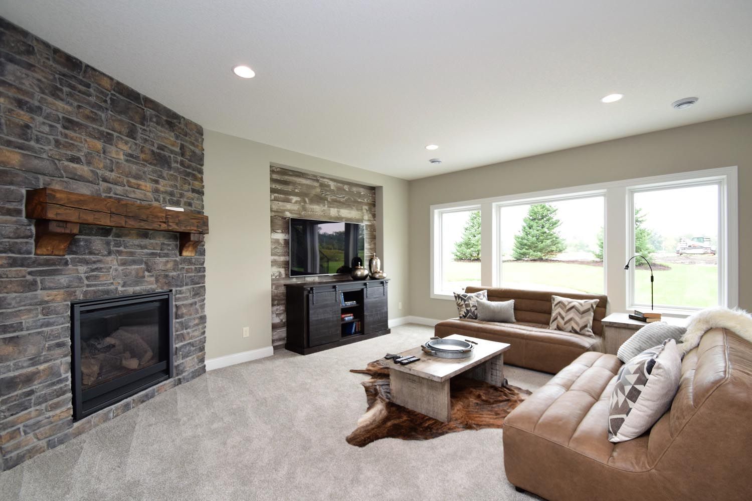 a living room with a couch , fireplace and television