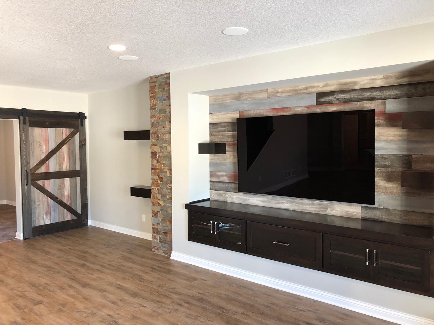 a living room with a flat screen tv mounted on the wall