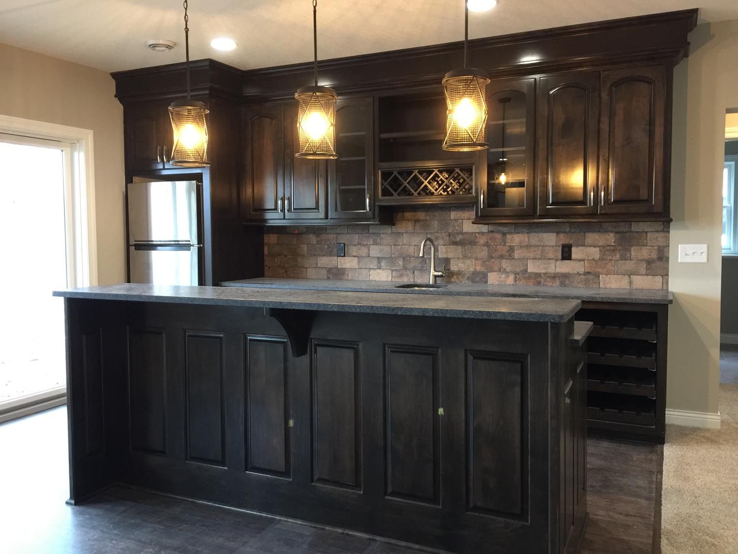 a kitchen with black cabinets and a large island