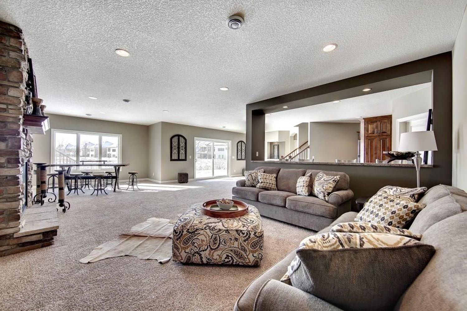 a living room filled with furniture and a large mirror