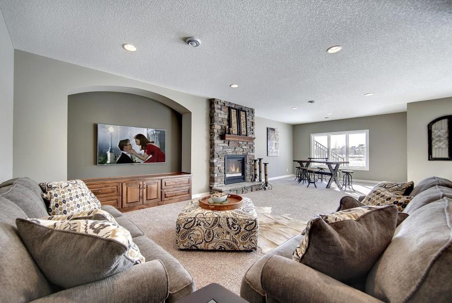 a living room with a fireplace and a flat screen tv