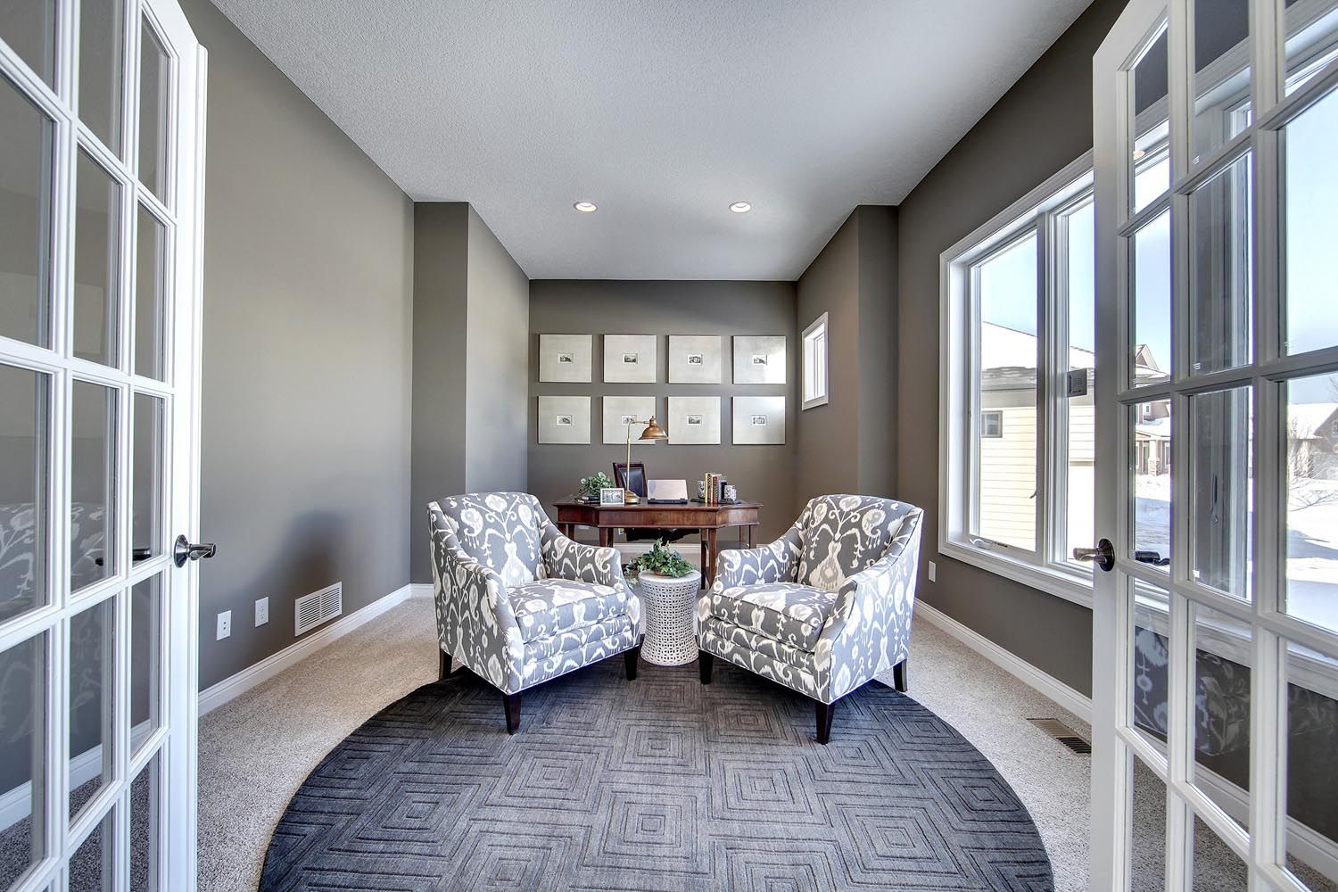 a home office with two chairs and a desk