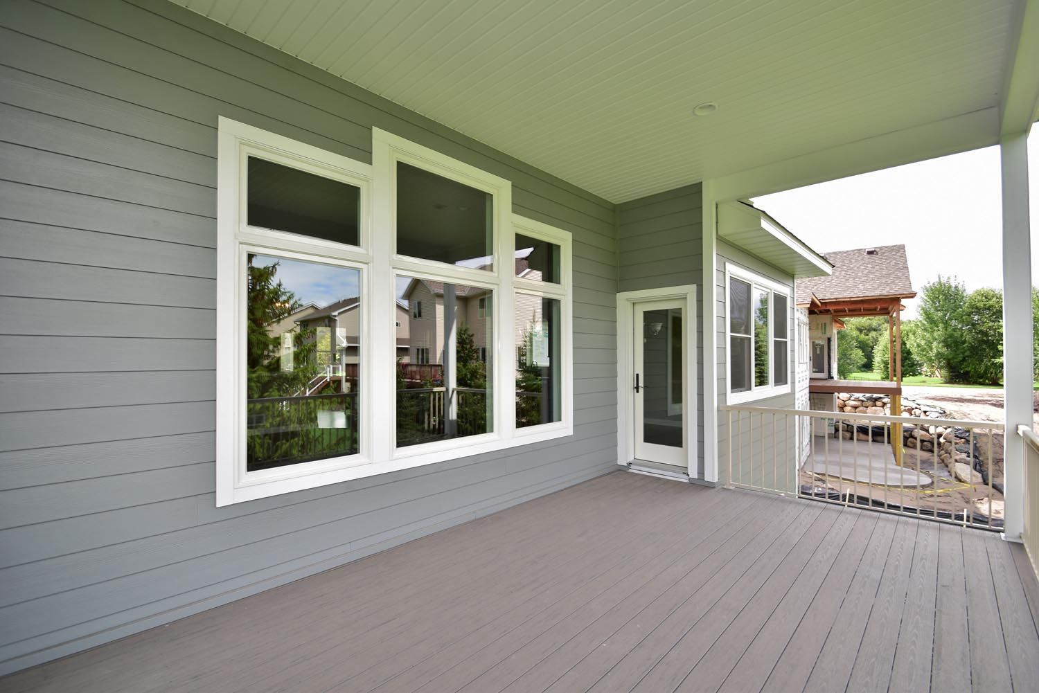 a large porch with a lot of windows and a sliding glass door