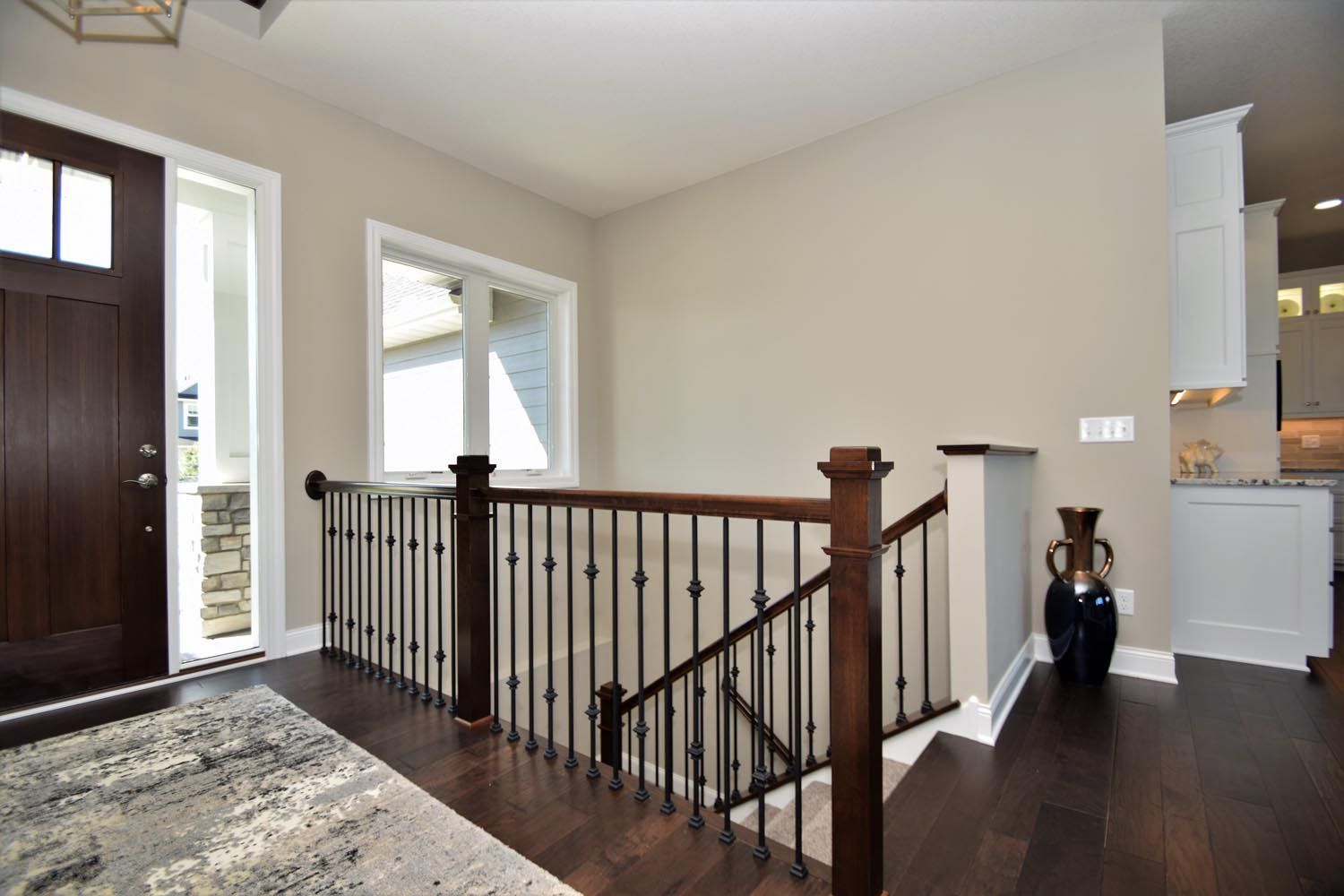 a hallway with a staircase leading up to the second floor of a house