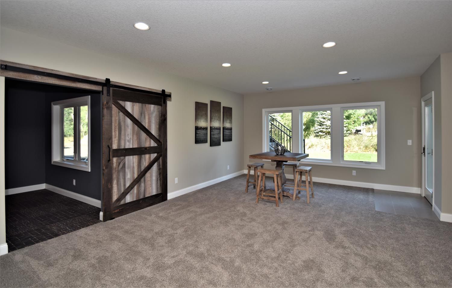 there is a sliding barn door in the middle of the room