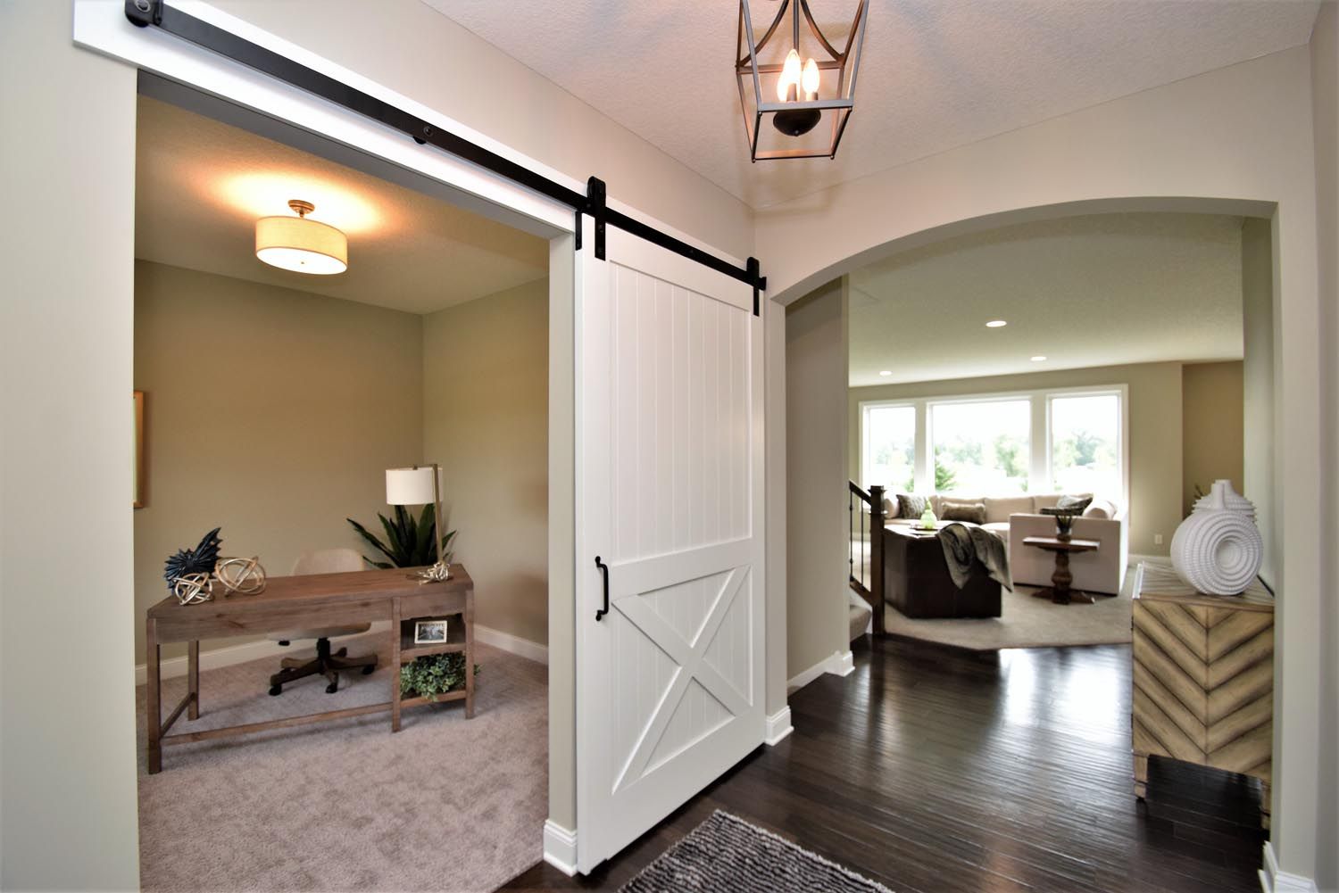 a sliding barn door is open to a home office