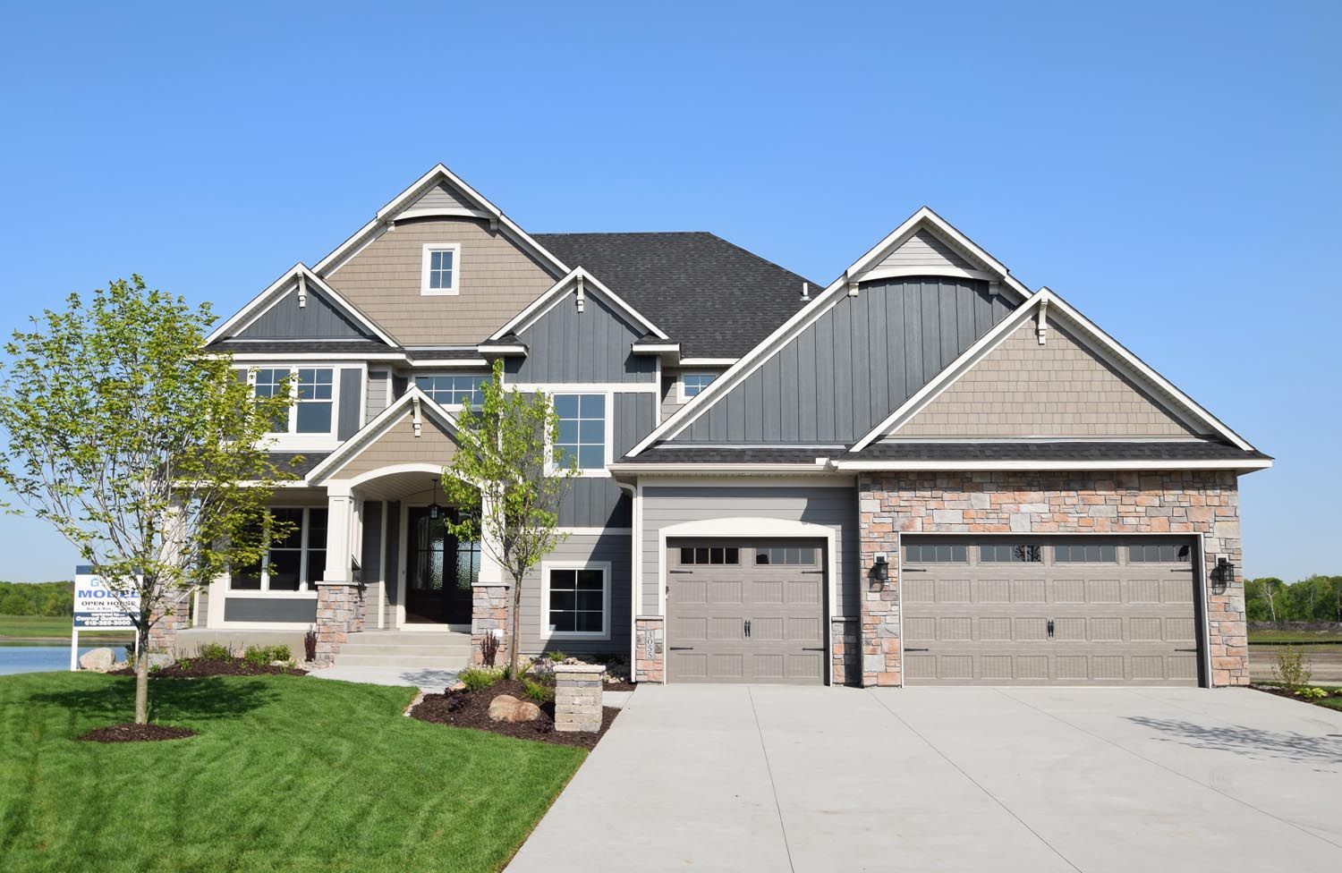 a large house with a lot of windows and a garage