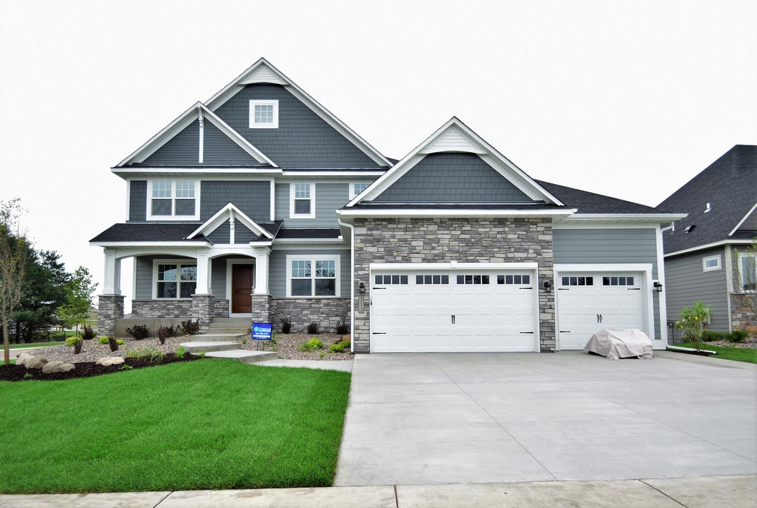 a large house with a lot of windows and a large driveway