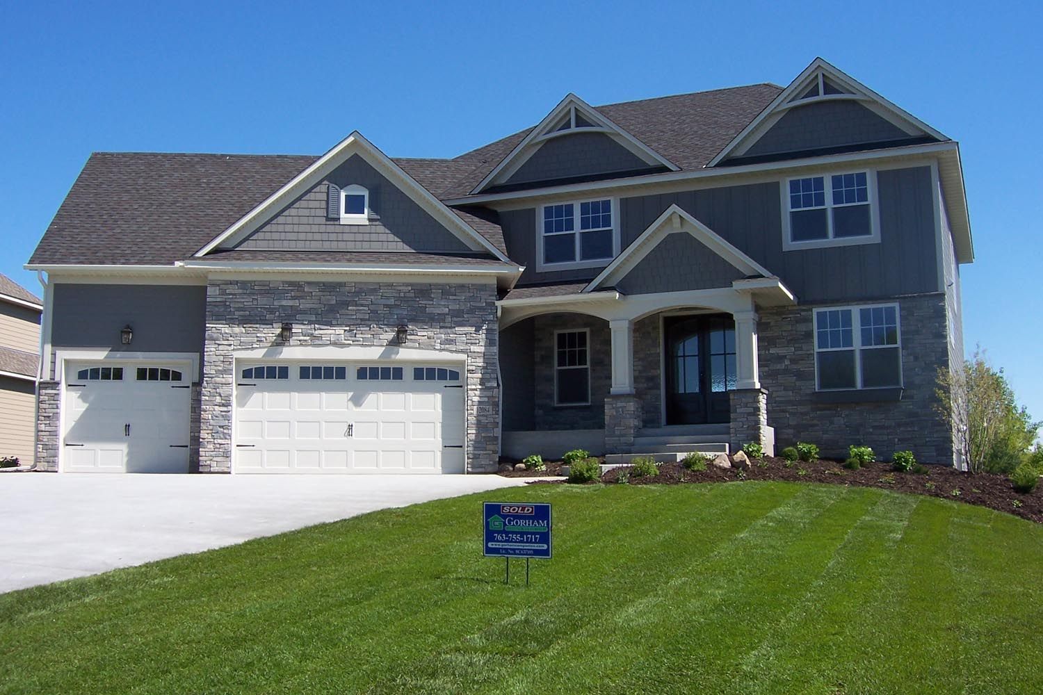 a large house with a sign in front of it