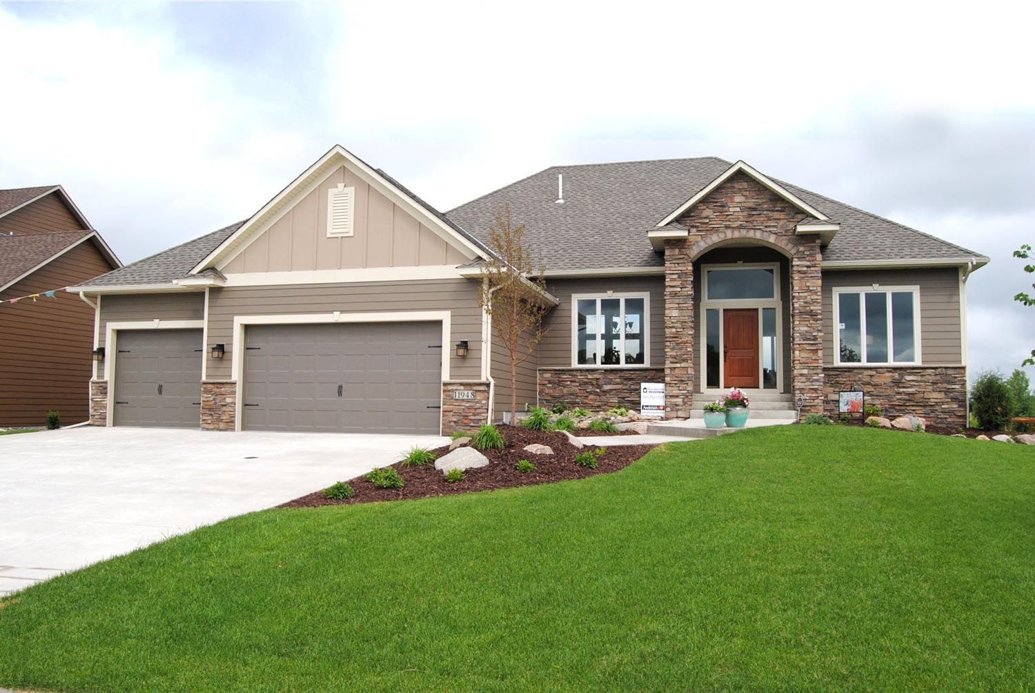 a large house with a lush green lawn in front of it