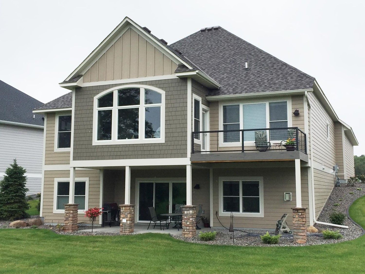 a large house with a balcony and a lot of windows