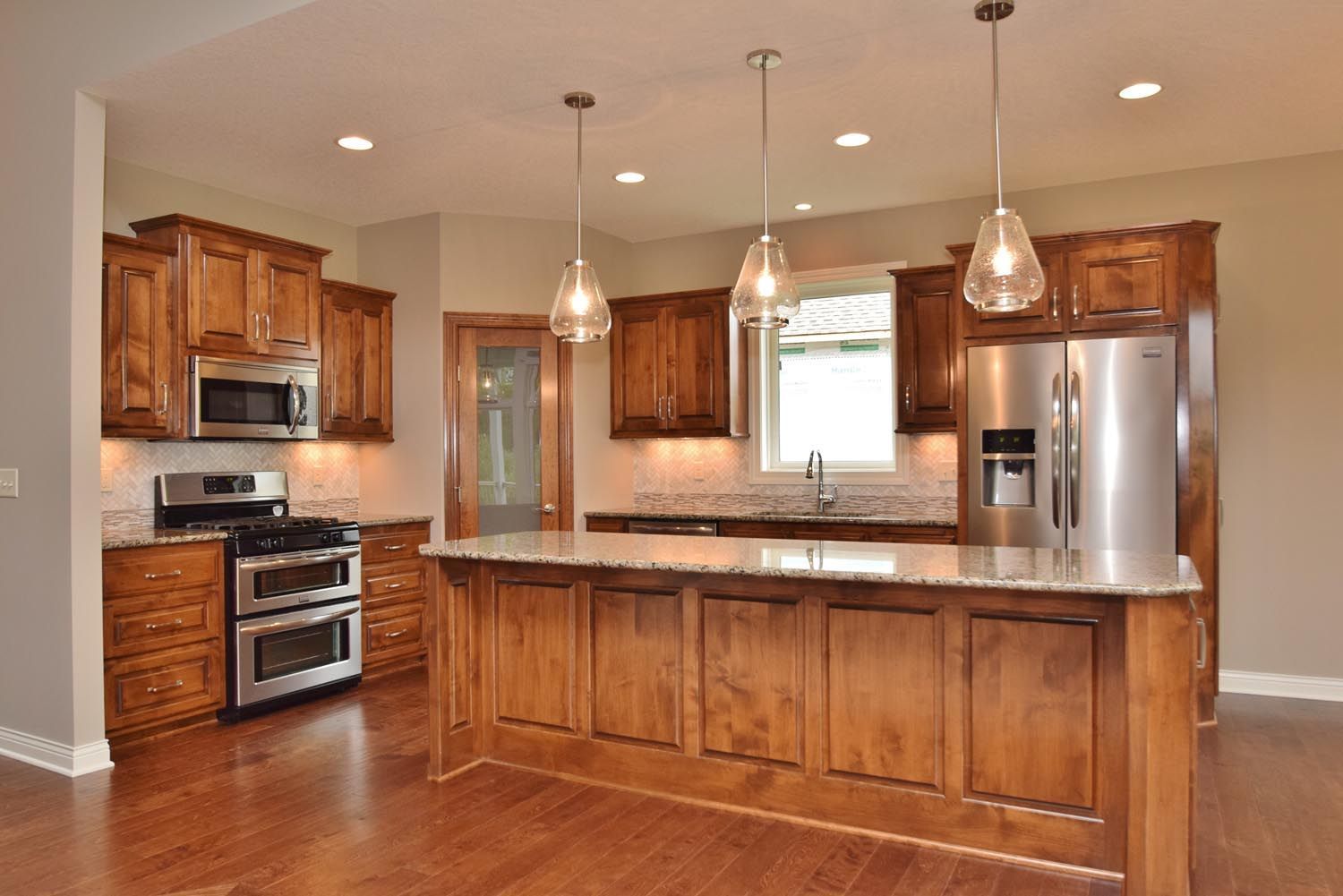 a kitchen with stainless steel appliances and wooden cabinets