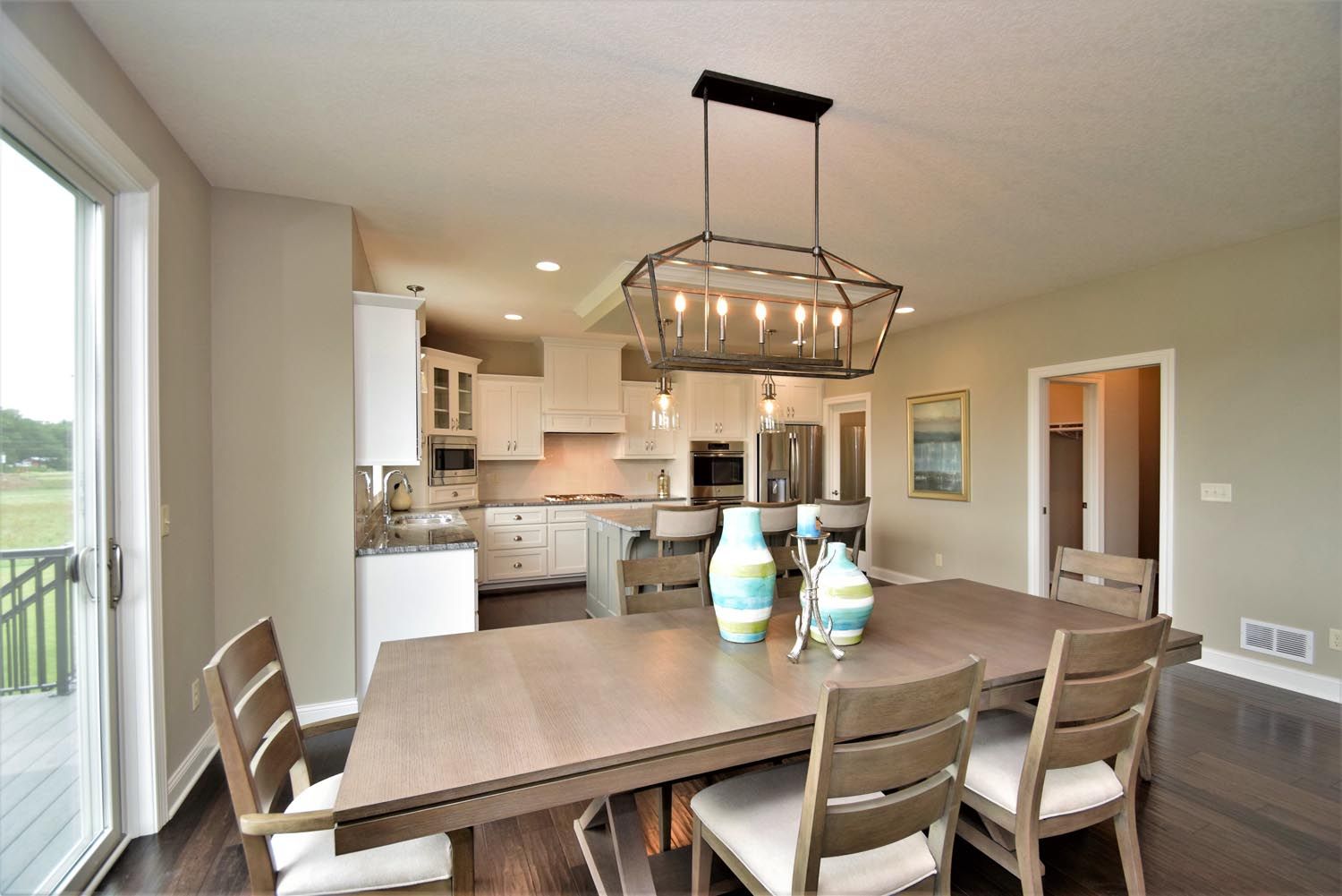 a dining room with a table and chairs and a chandelier