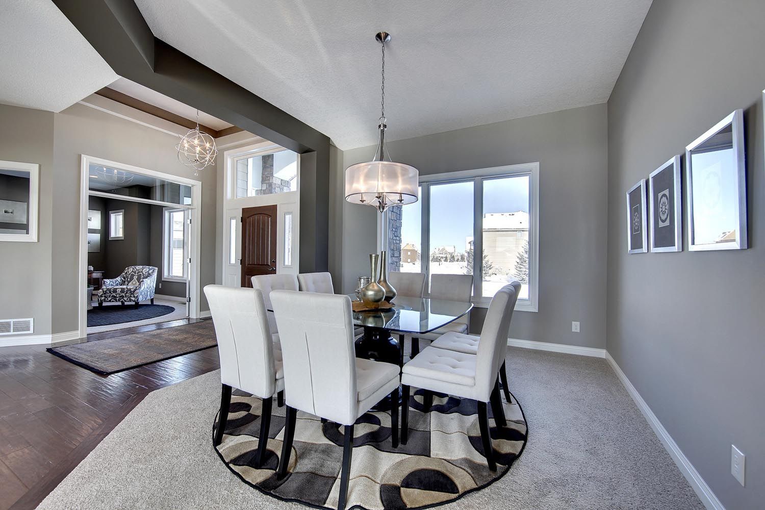 a dining room with a round table and chairs