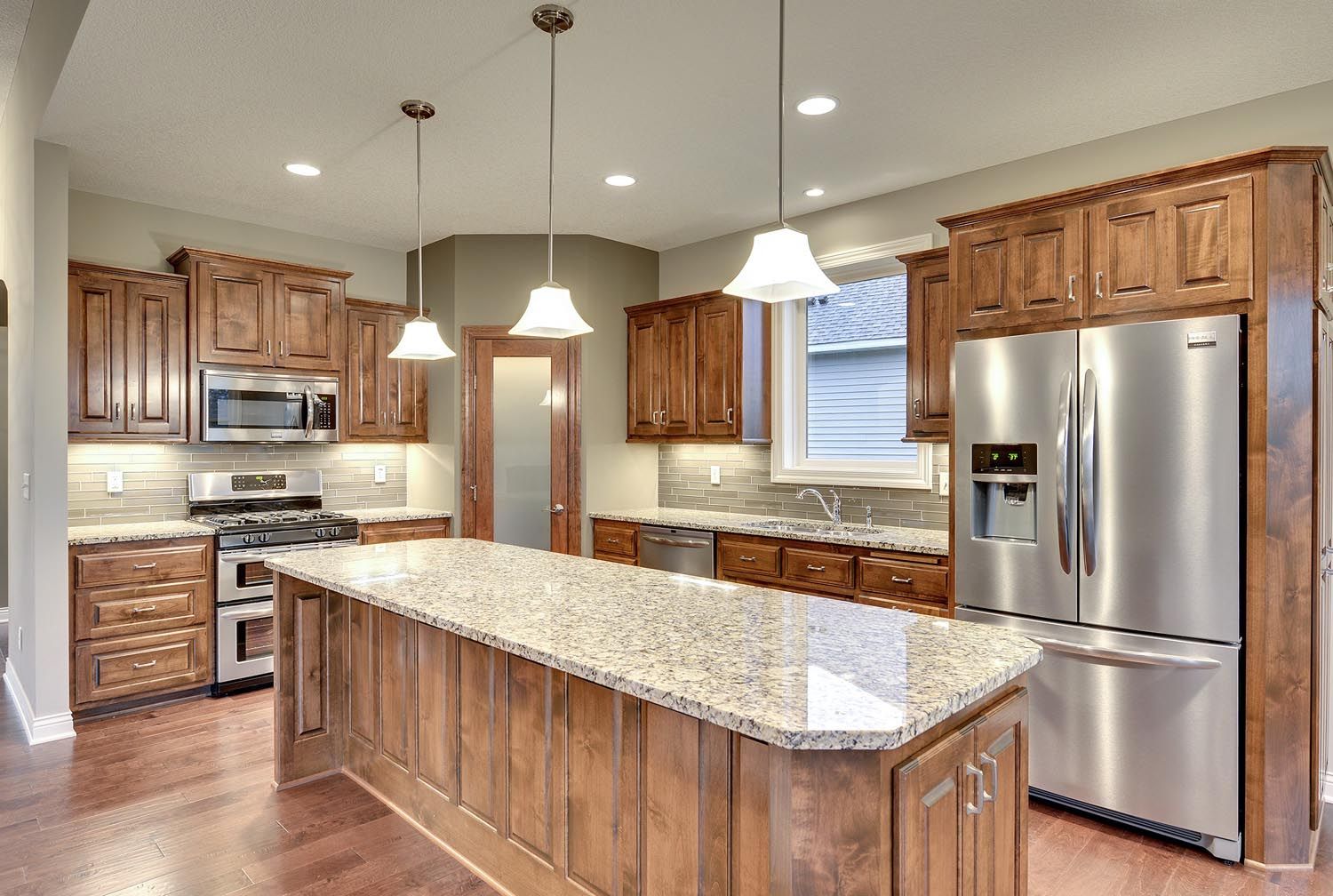 a kitchen with stainless steel appliances and granite counter tops