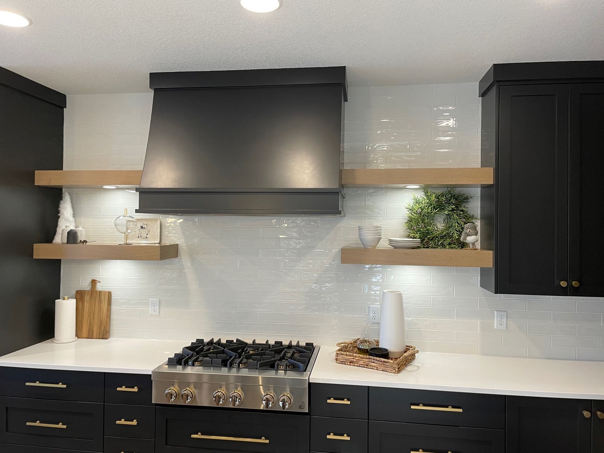 a kitchen with black cabinets and a stove top oven .