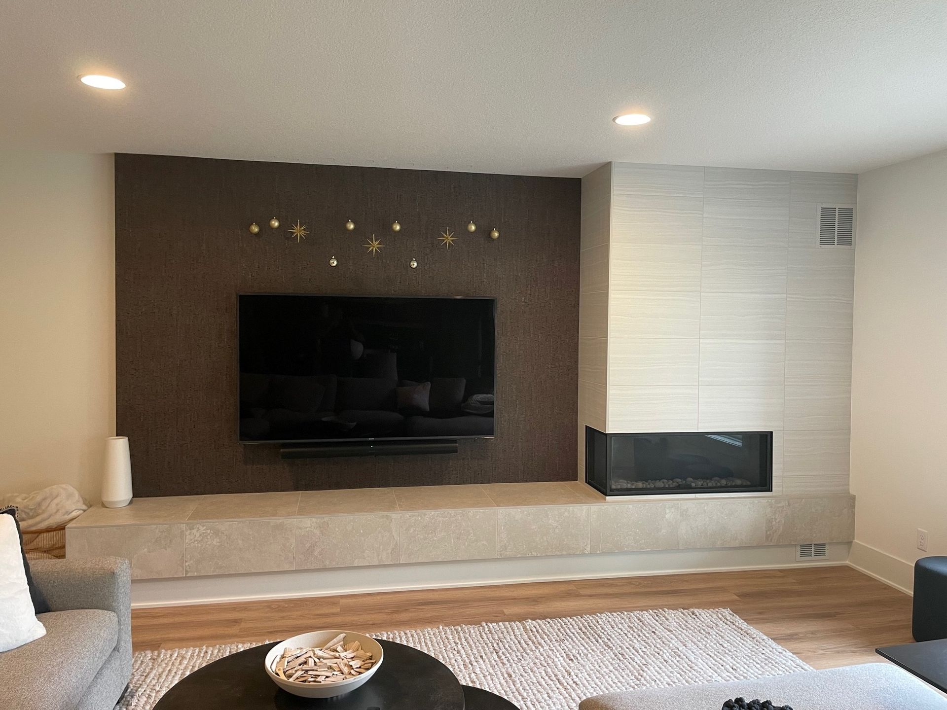 a living room with a fireplace and a flat screen tv on the wall
