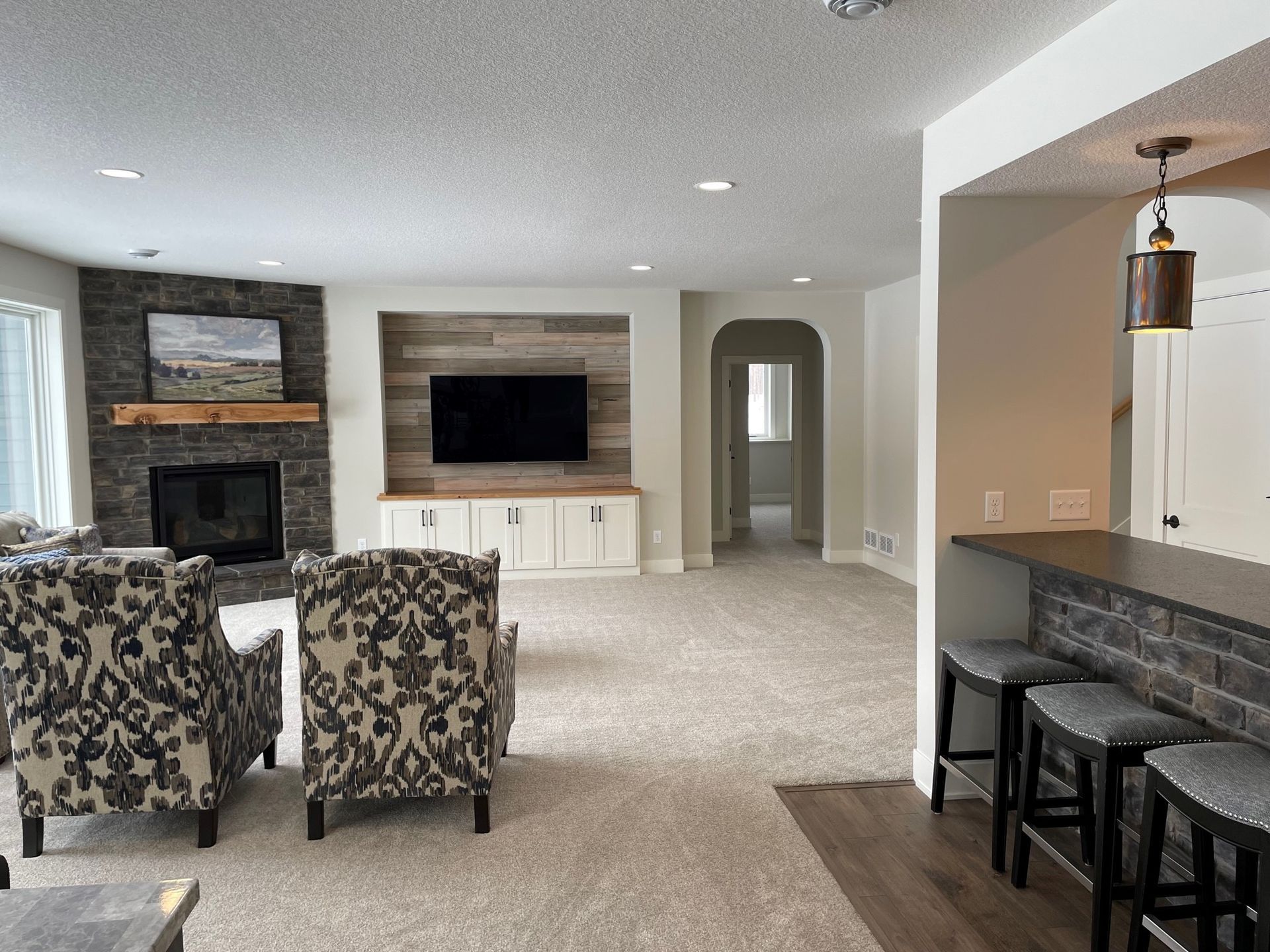 a living room with a fireplace and a flat screen tv