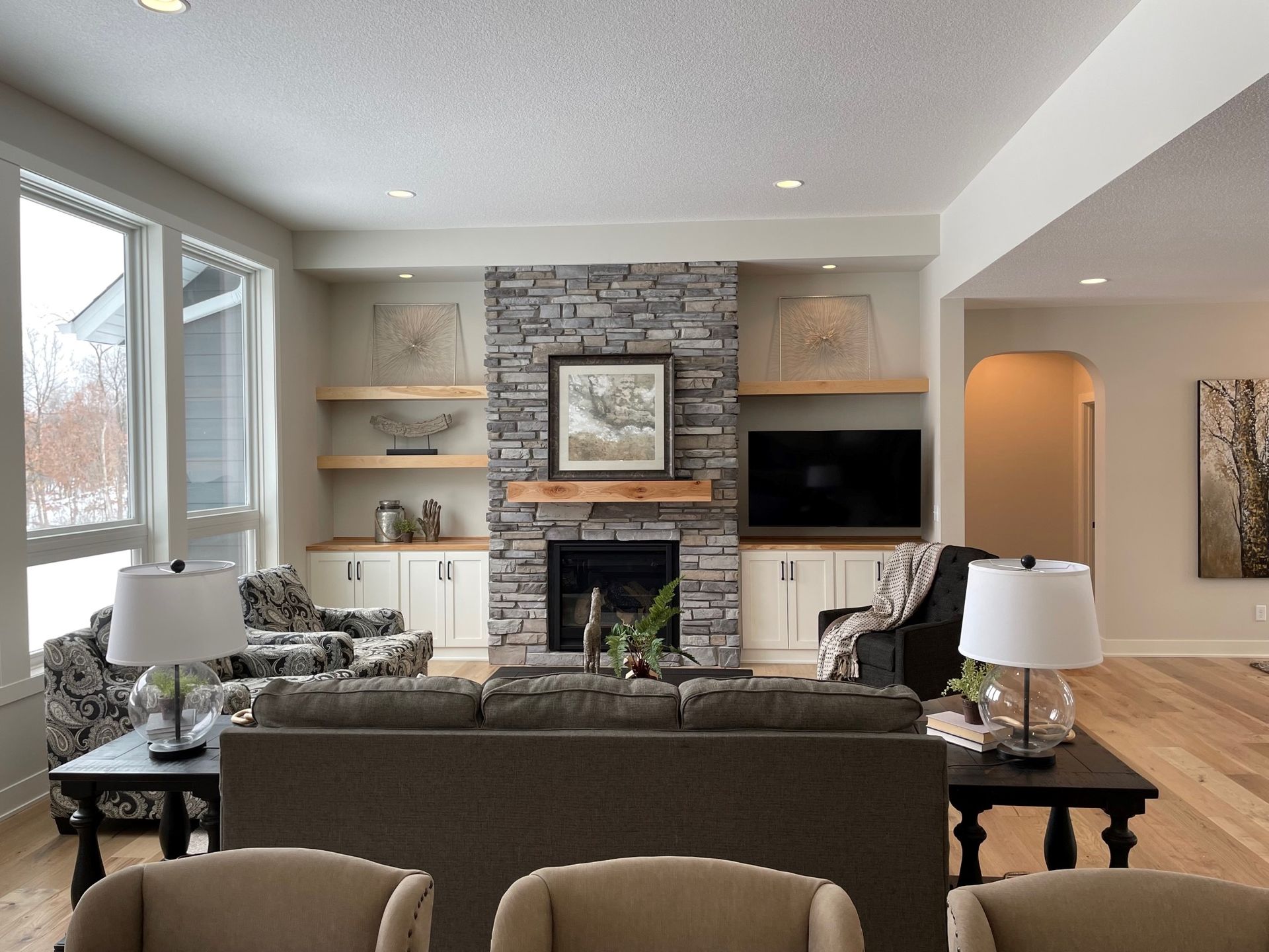 a living room with a couch and chairs and a fireplace