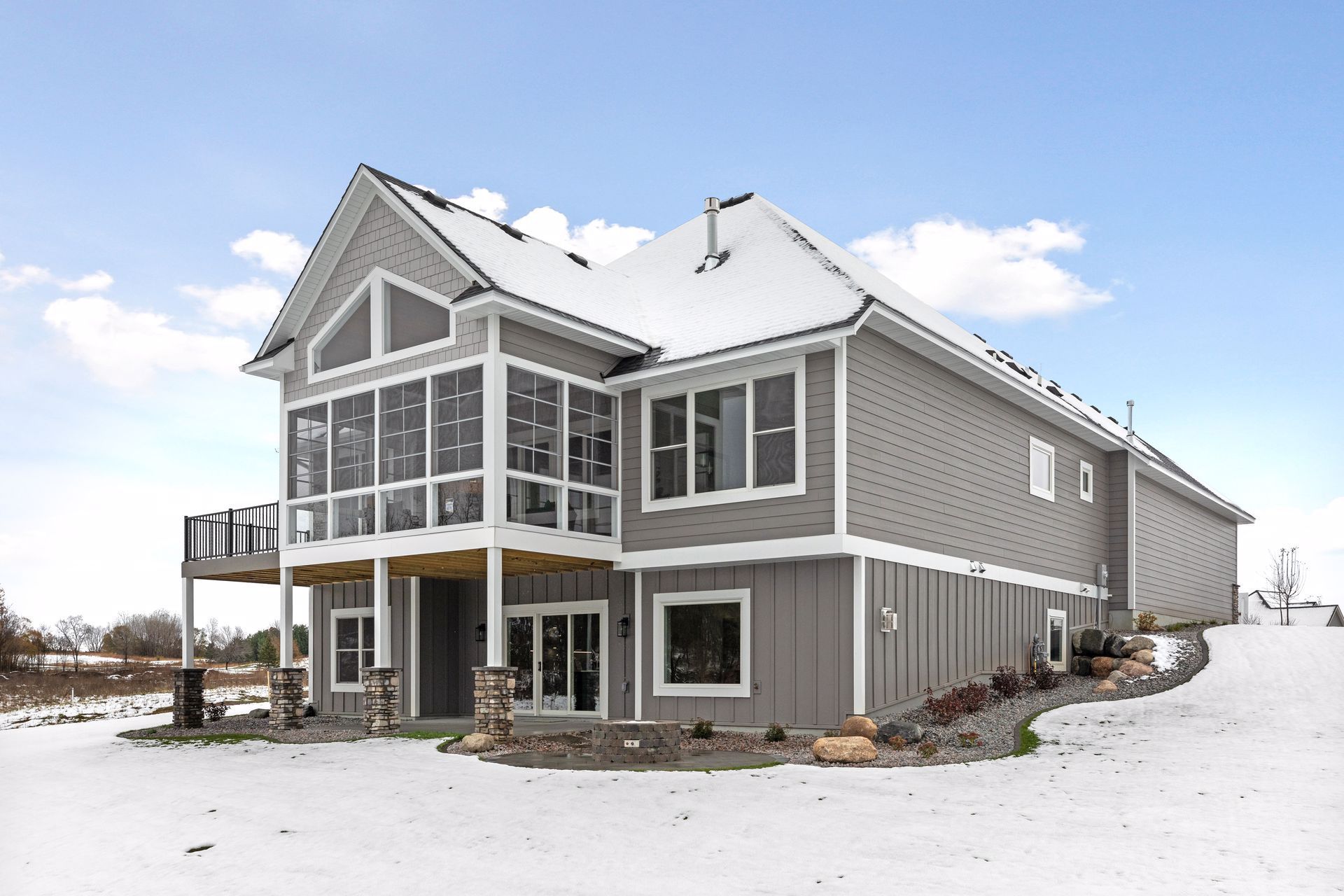 a large house with a lot of windows is covered in snow .