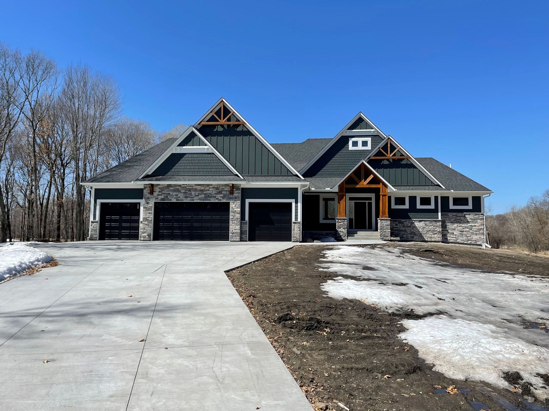 a large house with a concrete driveway leading to it