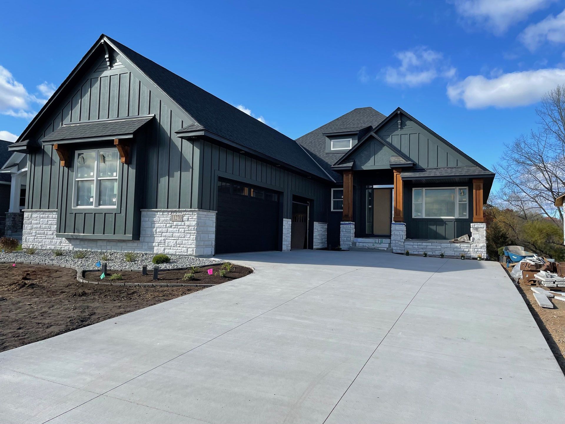 a large house with a concrete driveway in front of it