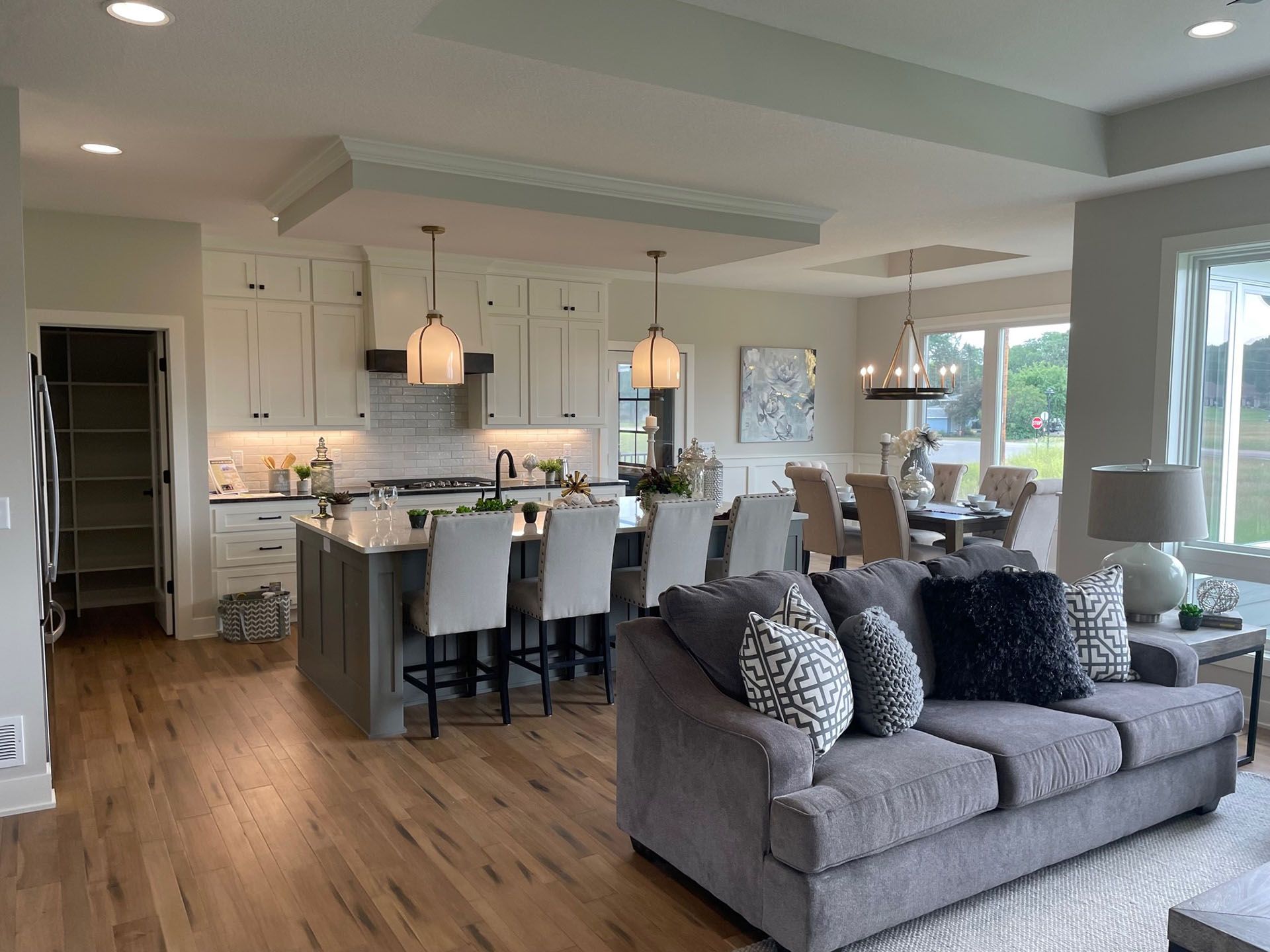 a living room with a couch and a kitchen in the background