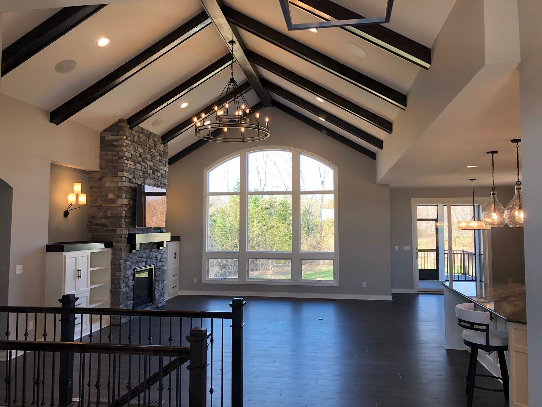 a living room with a vaulted ceiling and a fireplace