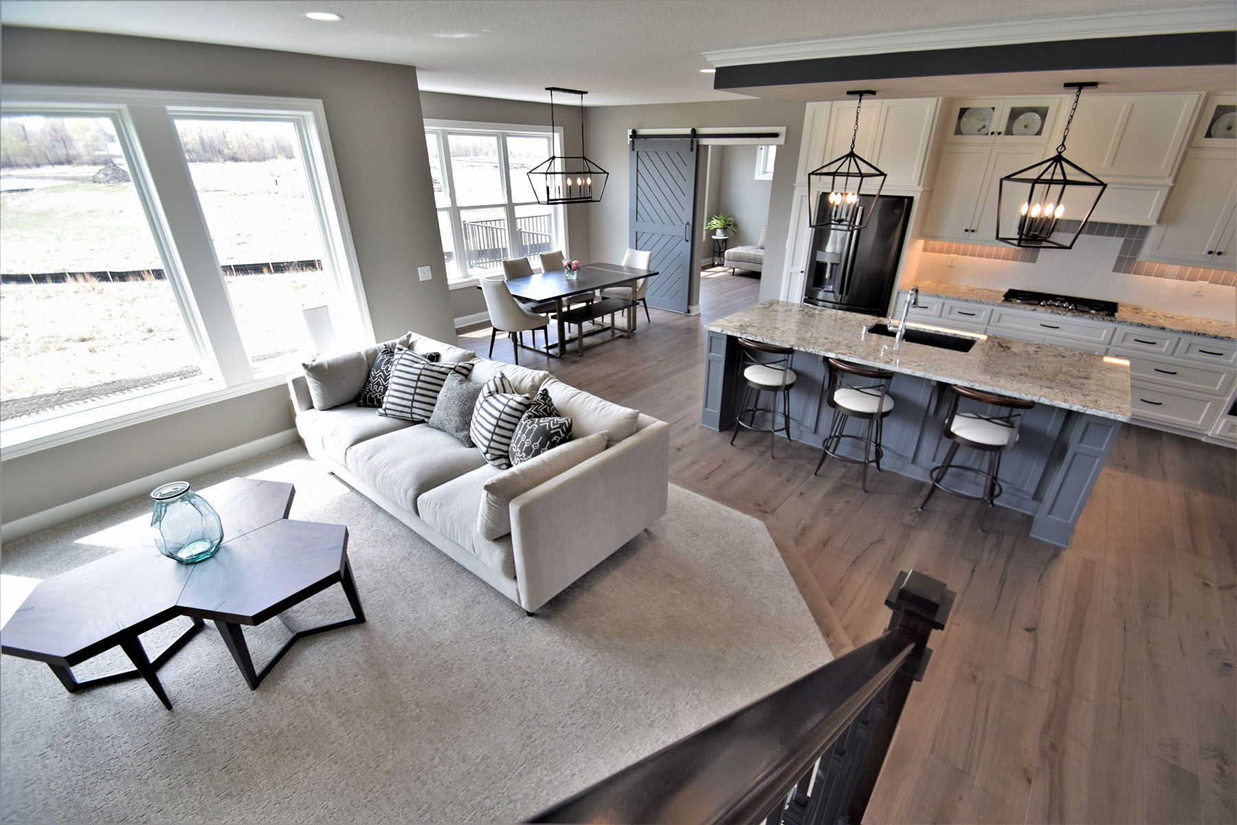 an aerial view of a living room and kitchen in a house