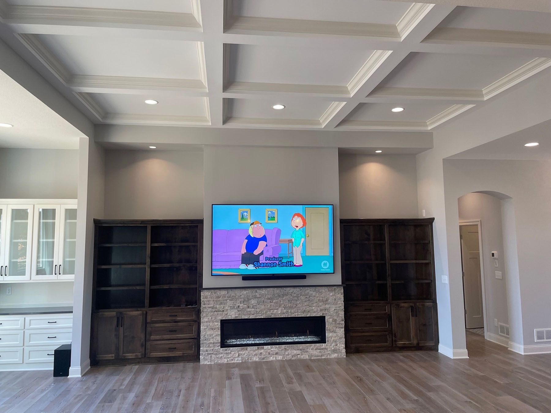 a living room with a fireplace and a flat screen tv