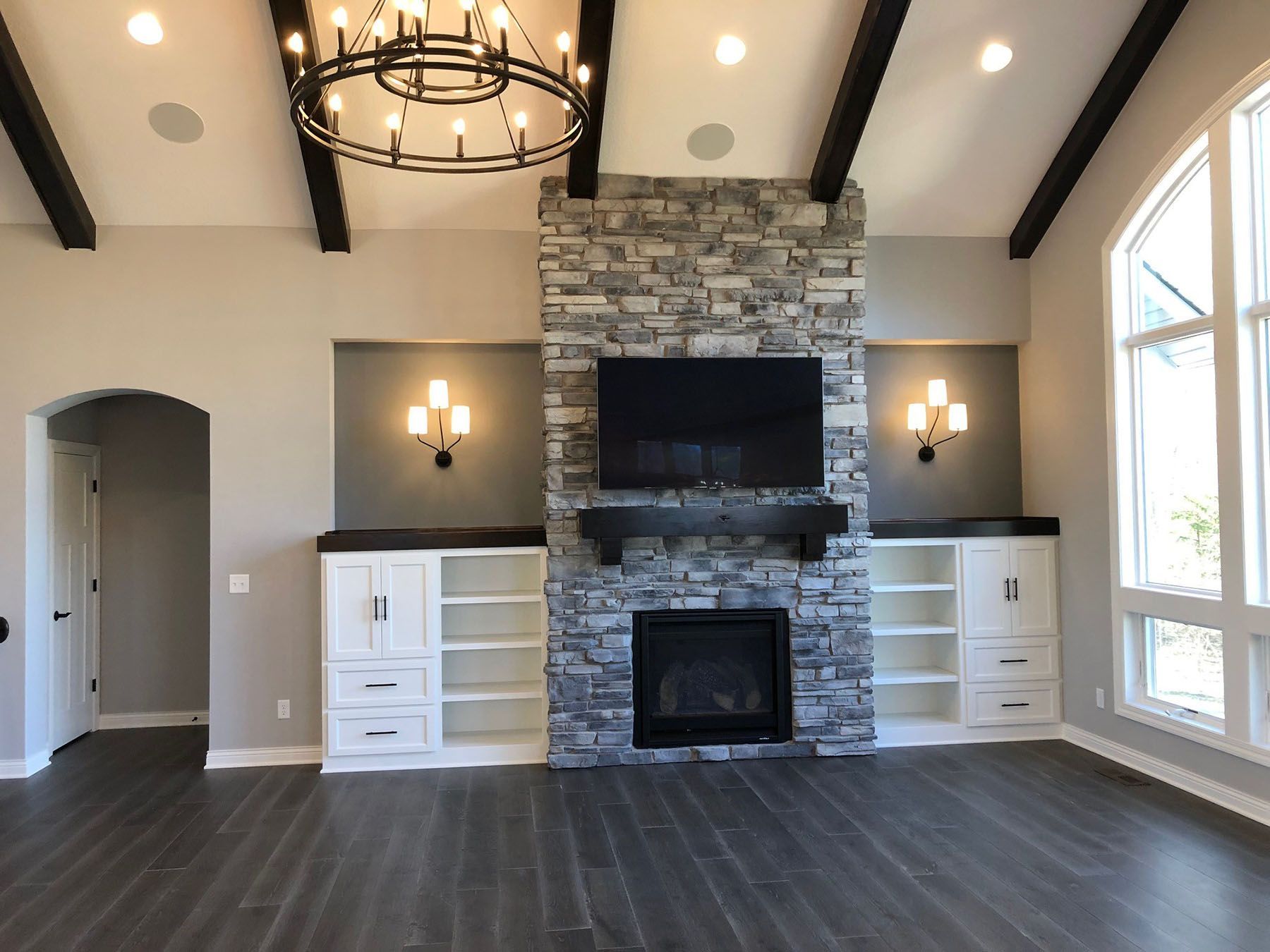 a living room with a fireplace and a flat screen tv