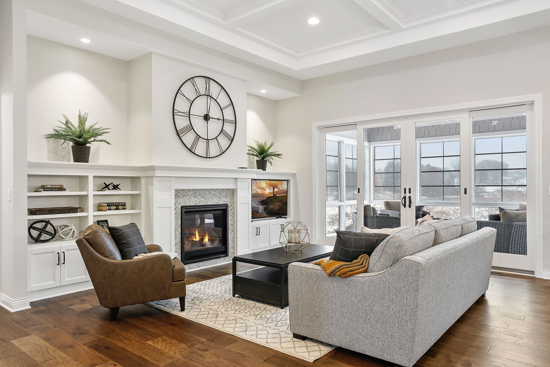 a living room with a fireplace , couch , chairs and a clock on the wall