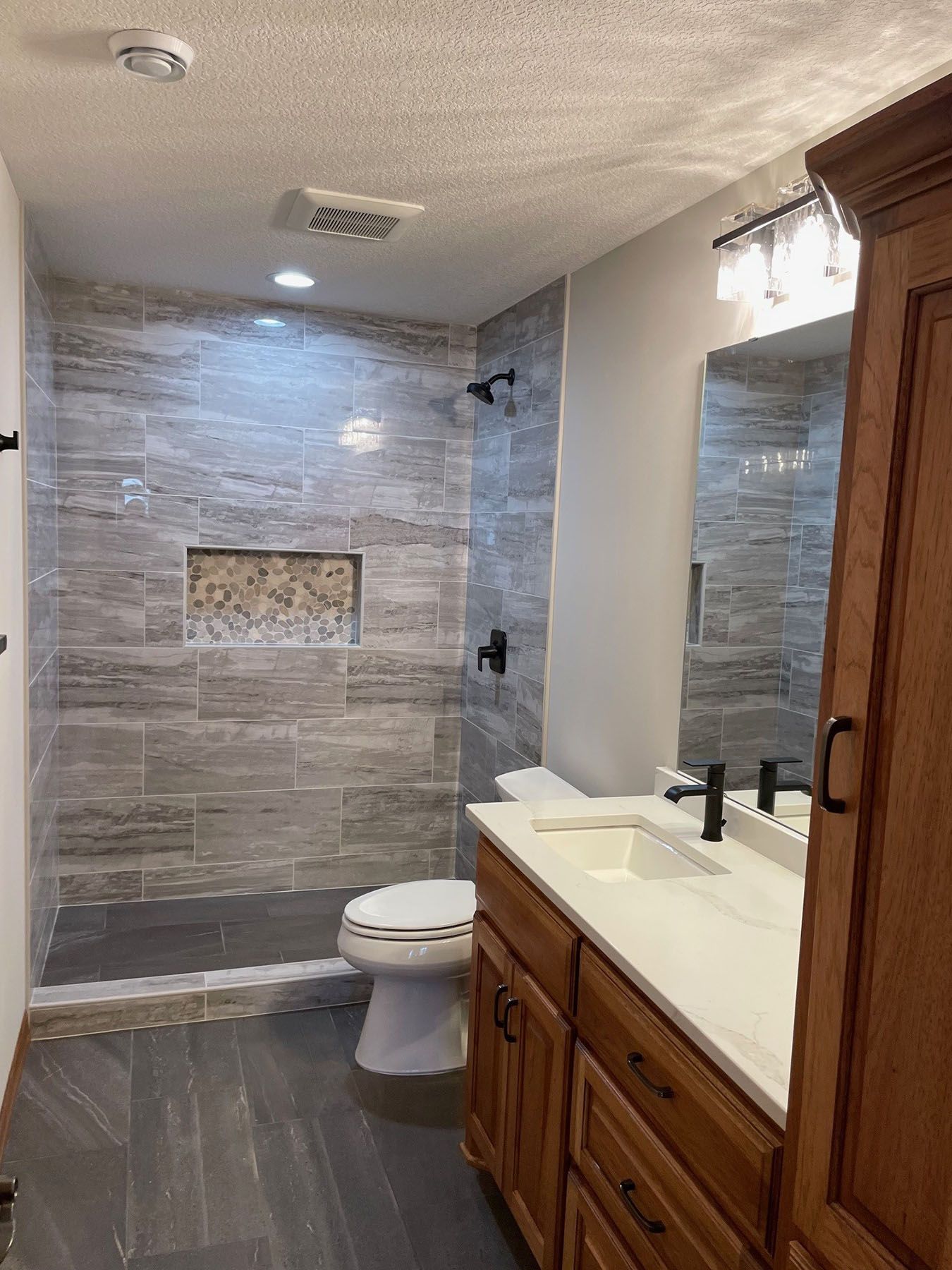 a bathroom with a toilet, sink, and shower