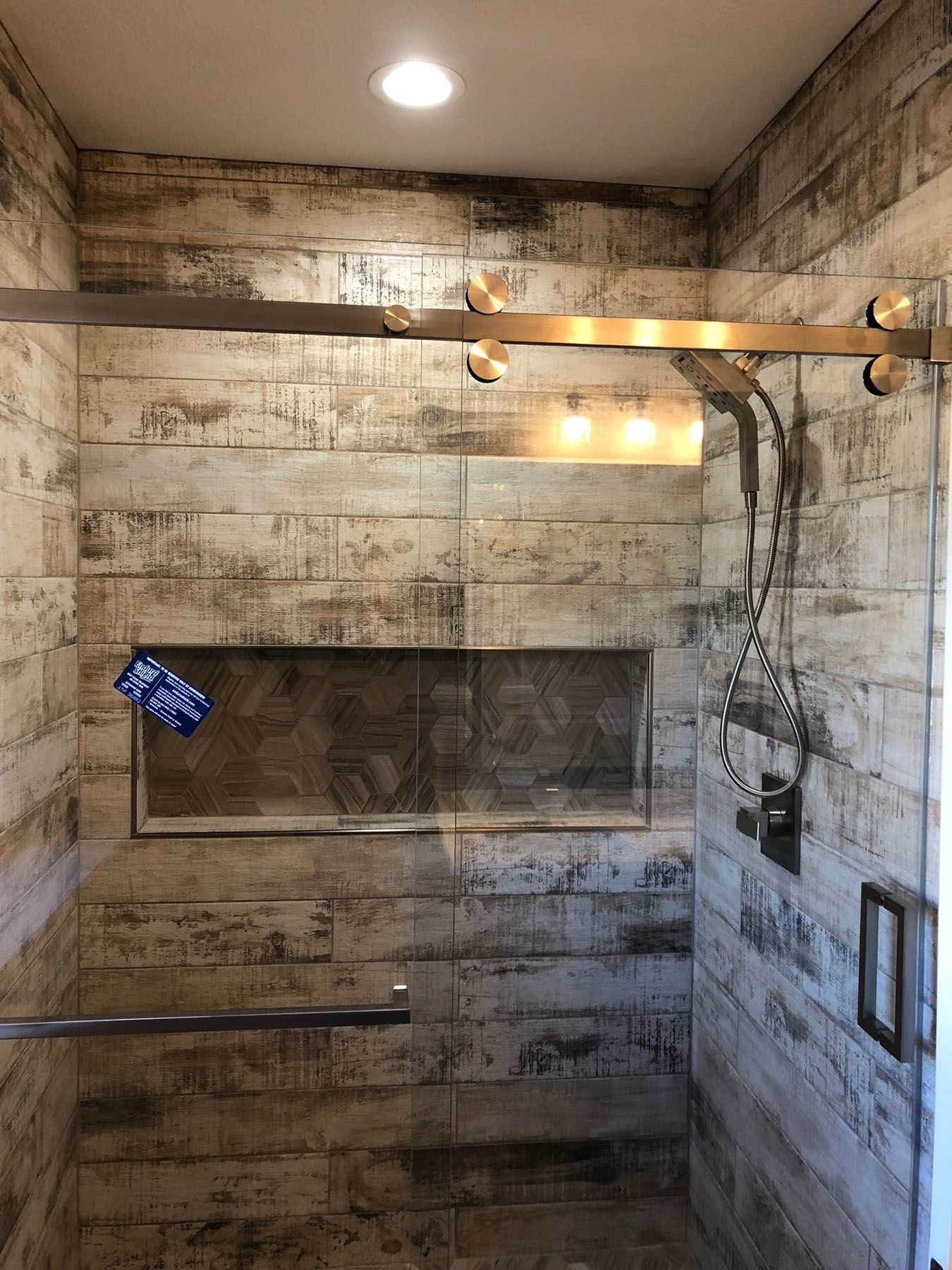 a bathroom with a walk in shower and a sliding glass door