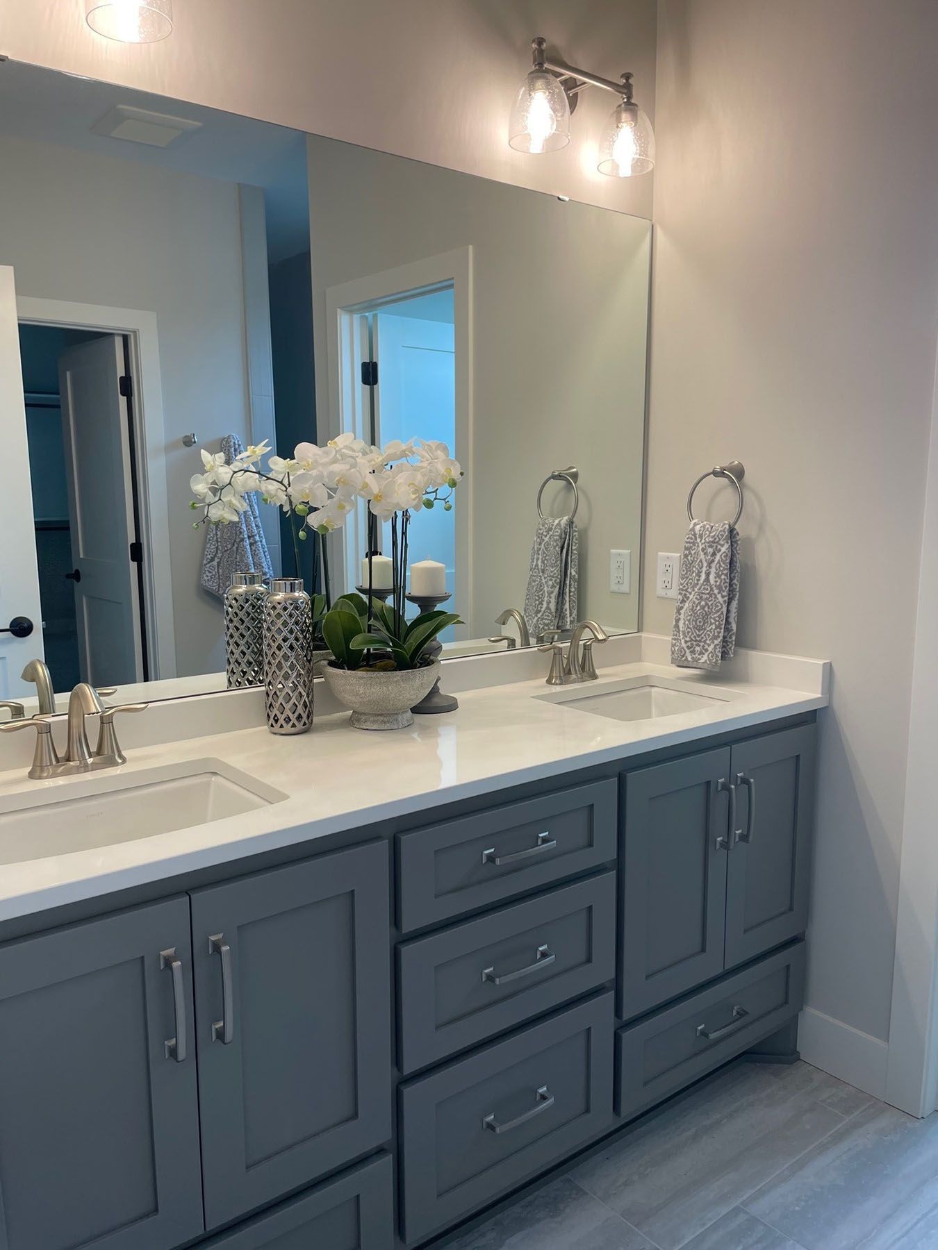 a bathroom with two sinks and a large mirror