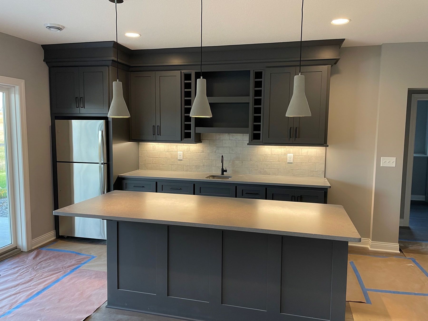 a kitchen with a large island and a refrigerator