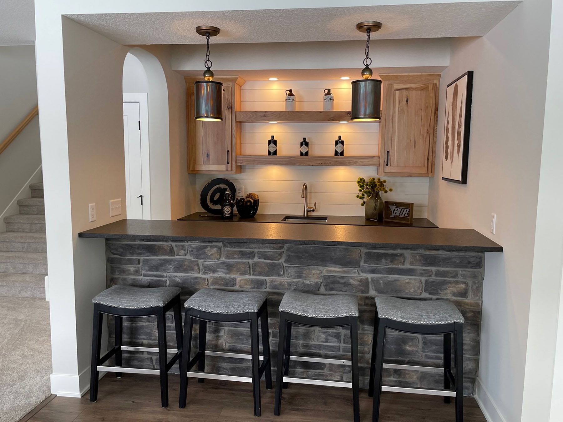 a kitchen with a bar and stools in it