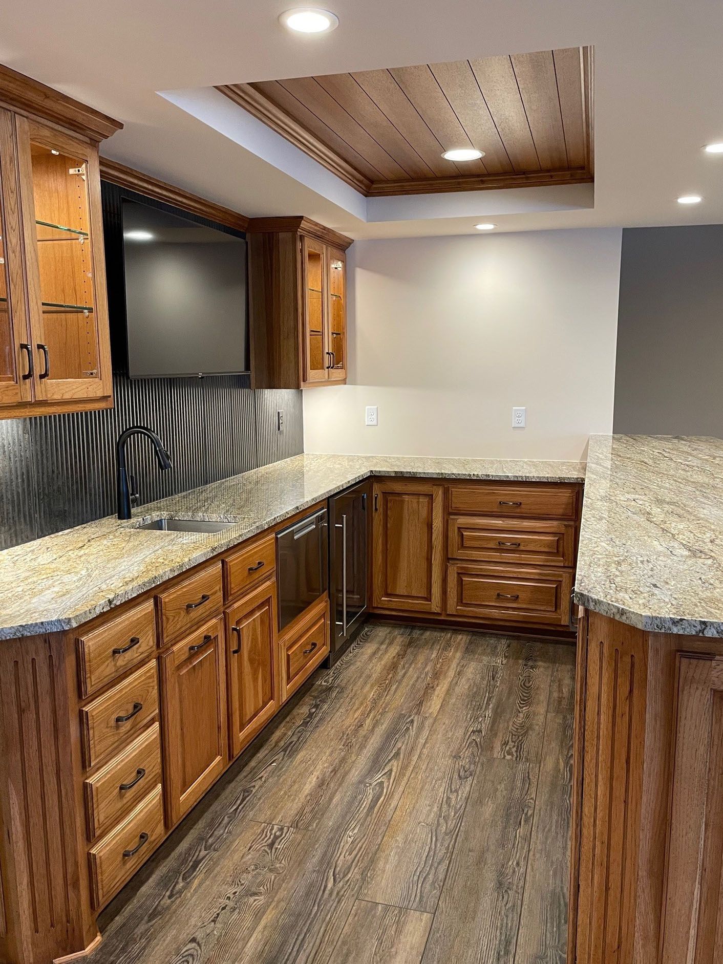 a kitchen with wooden cabinets and granite countertops
