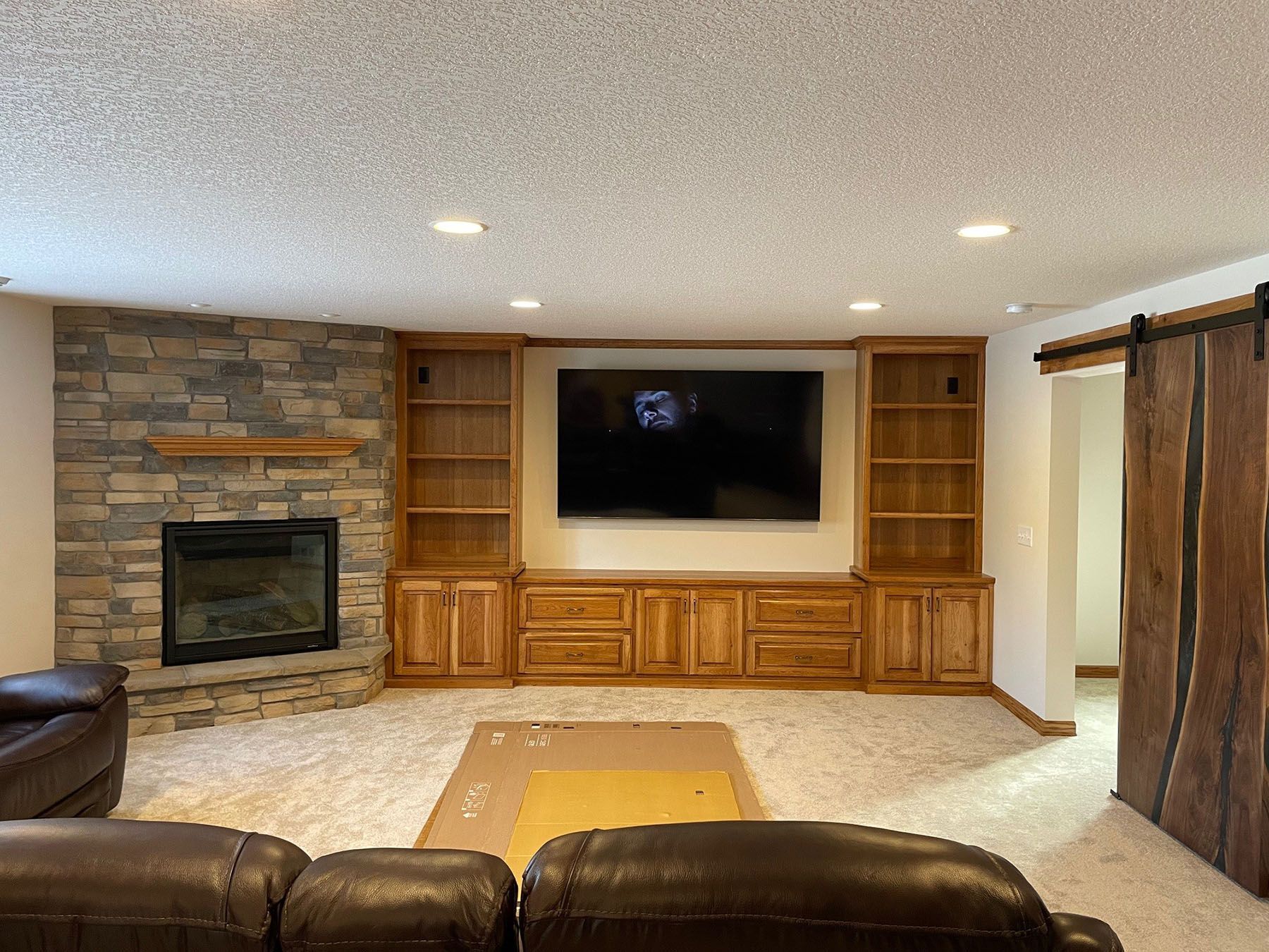 a living room with a fireplace and a flat screen tv