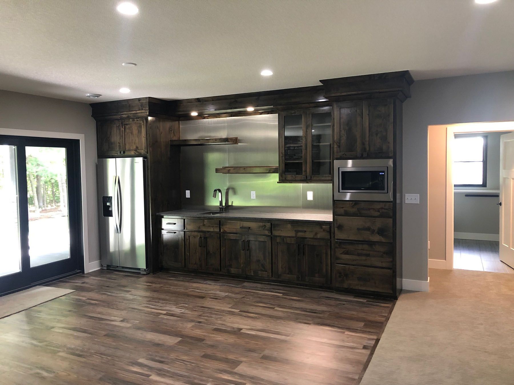 a kitchen with stainless steel appliances and wooden cabinets