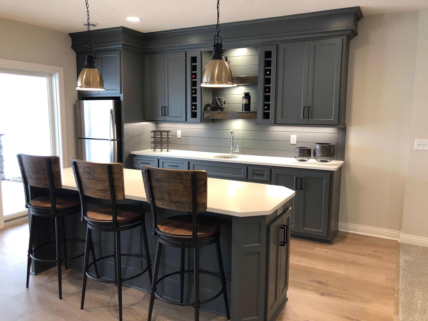 a kitchen with a large island and stools